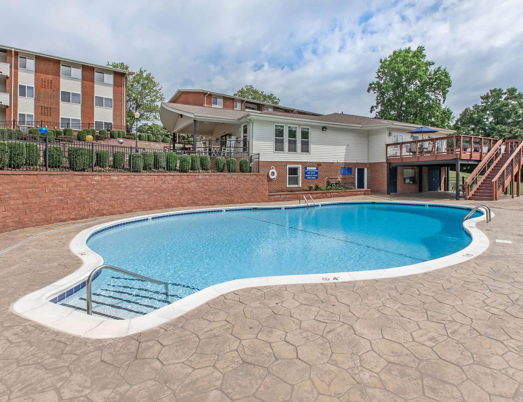outdoor community swimming pool and well-manicured landscape